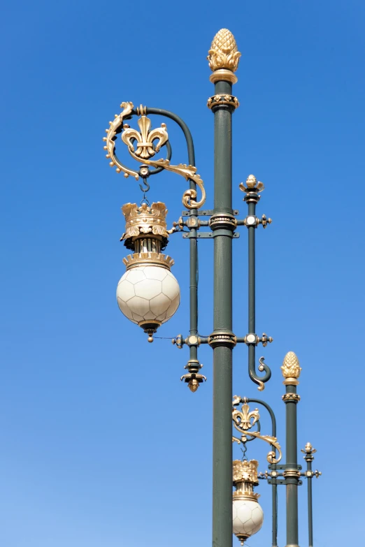 ornate street lights attached to a light pole