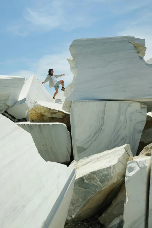 a man is jumping on his skateboard over large rocks