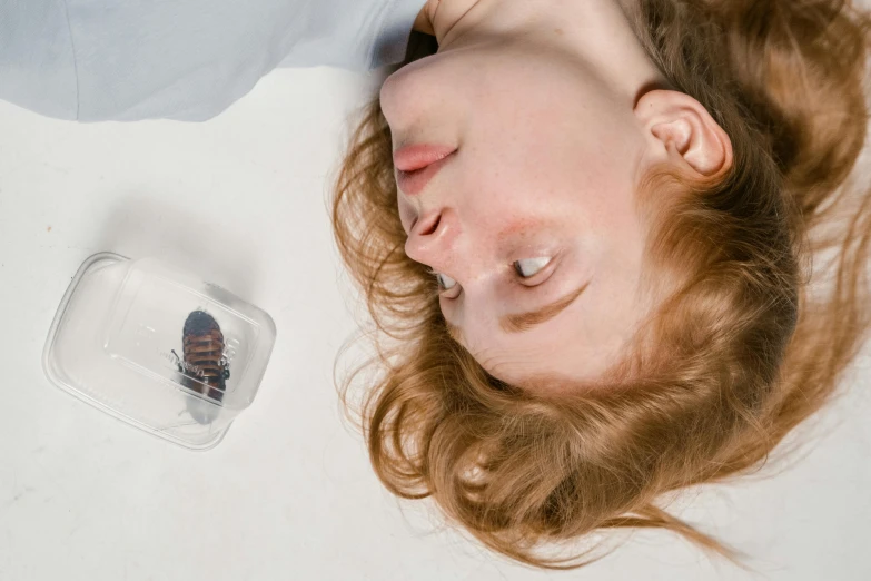 a lady laying on the floor with her head resting on a case