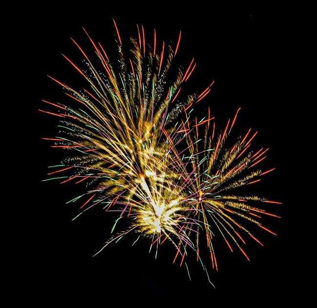 a fireworks display in the air on a black night