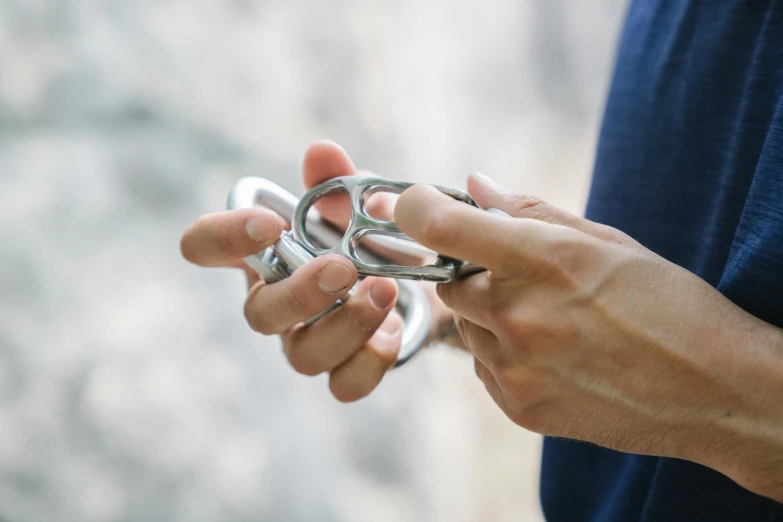 a person is holding two pairs of rings in their hands