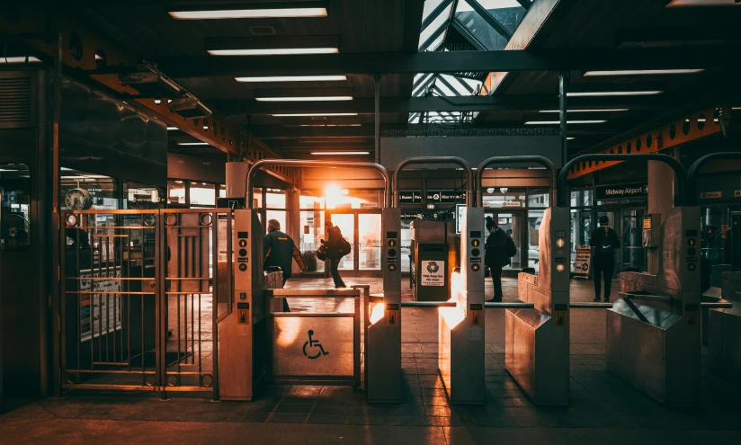 people are standing in the sunlight at an open train station