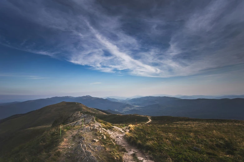 a dirt path on the top of a hill in a scenic view