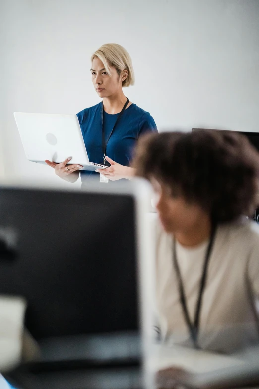 women sitting in front of computers working on their laptops