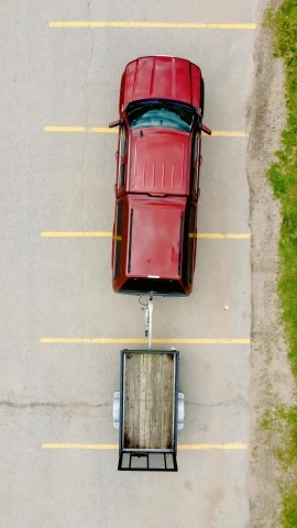an aerial view of a red car parked in a parking lot