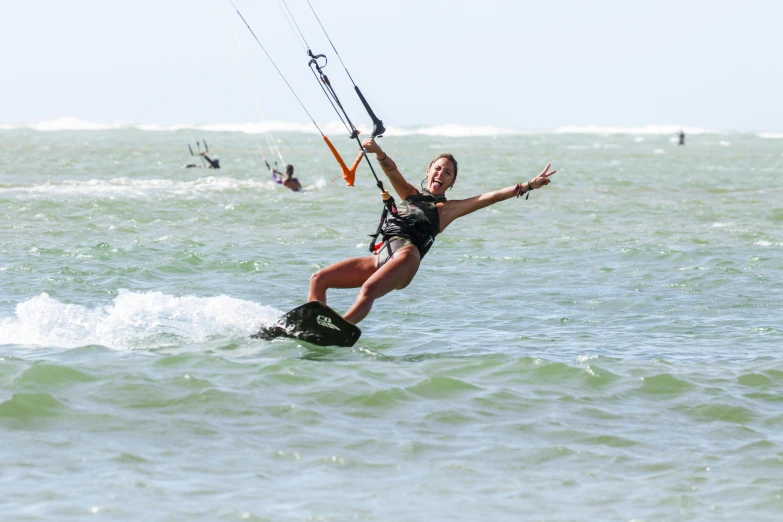 the young woman is holding onto an extreme kite