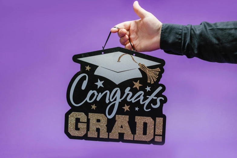 a sign with a graduate hat hanging from it