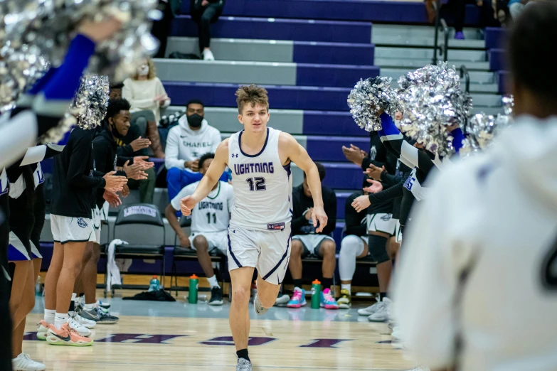 young men running onto the court in a game