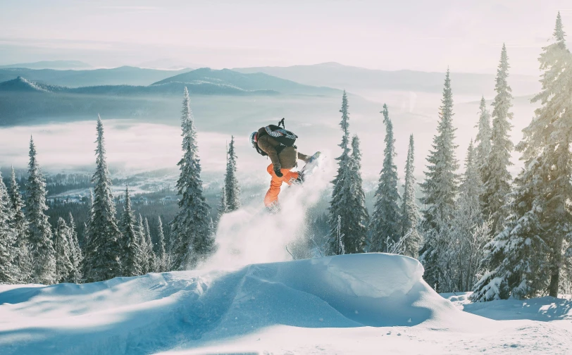 a person on a snowboard is going down the hill