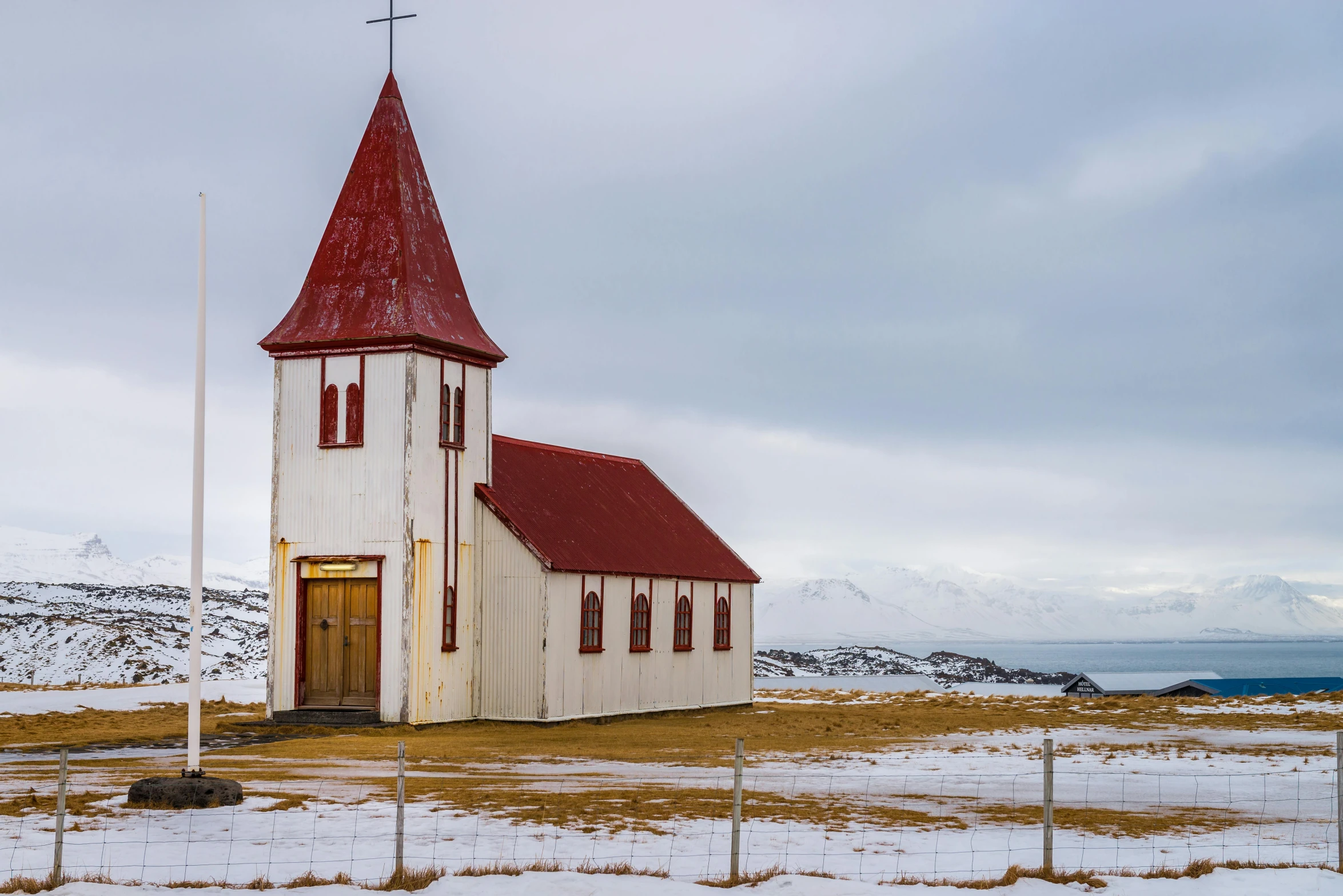 an old church with a steeple and a cross on top