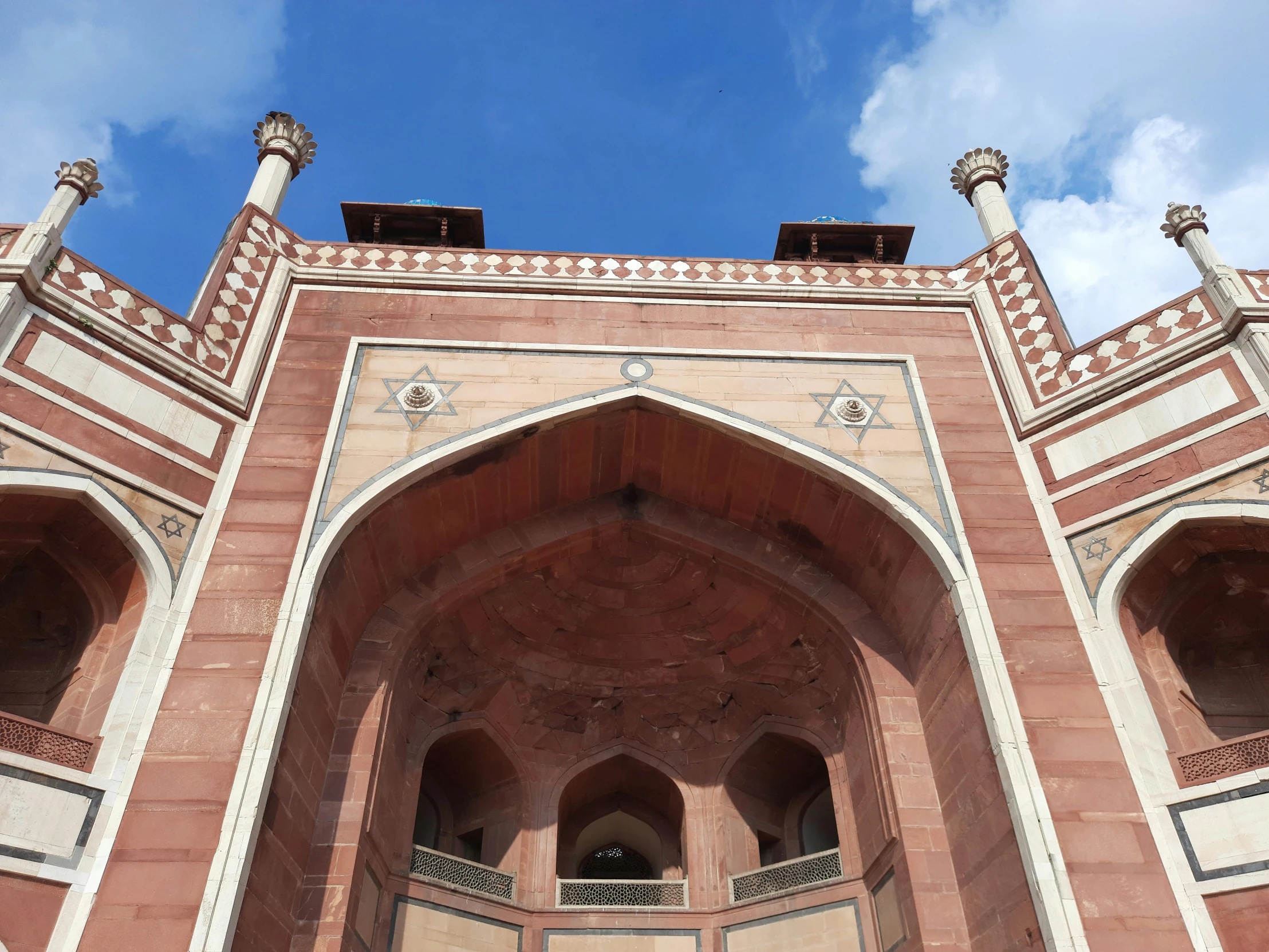 an arched and intricate building with a clock at the top