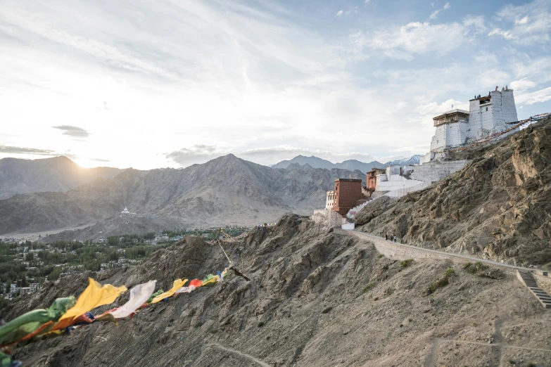 a mountain view with some buildings near a river