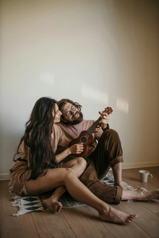 a man and a woman are sitting on the floor