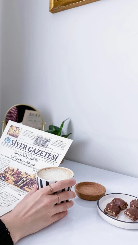 a woman reading a newspaper while eating