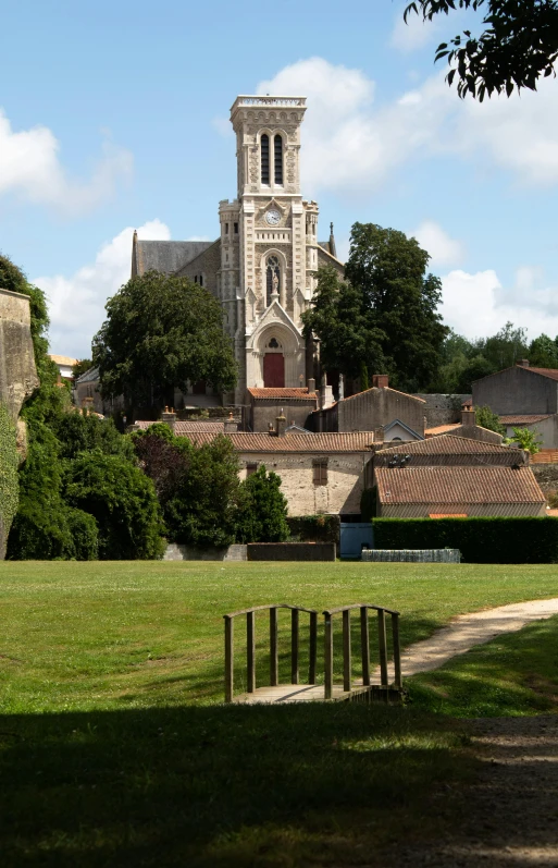 large tower on top of buildings next to park