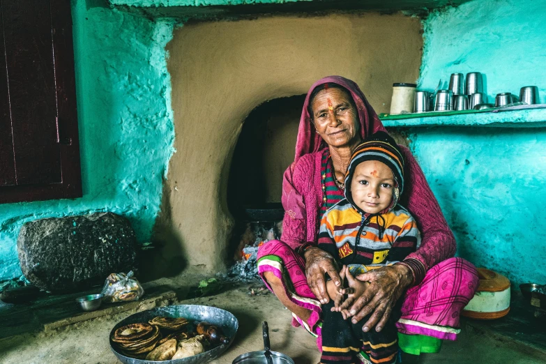 woman and child in doorway next to oven with food