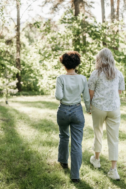 a woman walking beside her older sister holding hands