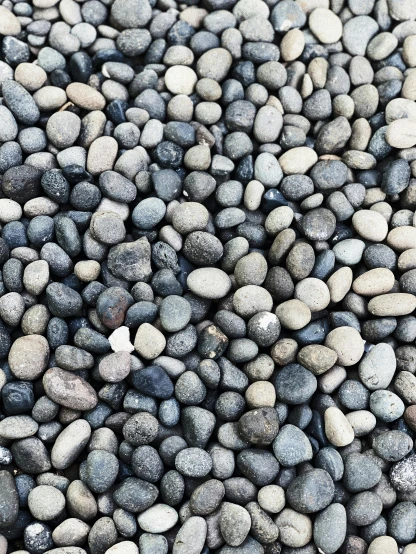 a rock floor with gray rocks next to it