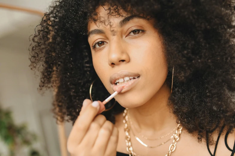 woman brushing her teeth with an open plastic toothbrush