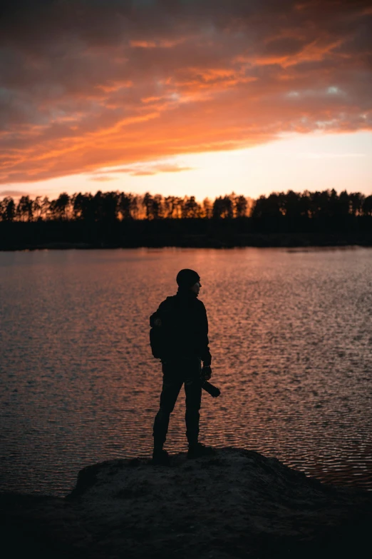 a person with a backpack at the water's edge