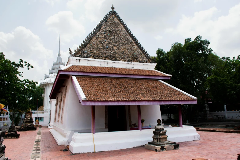 a small white building has a brown roof