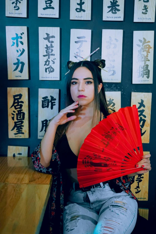 woman in japanese characters posing with red fan