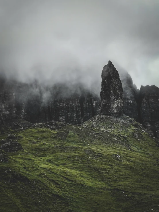 fog rolling in on a tall grass covered mountain