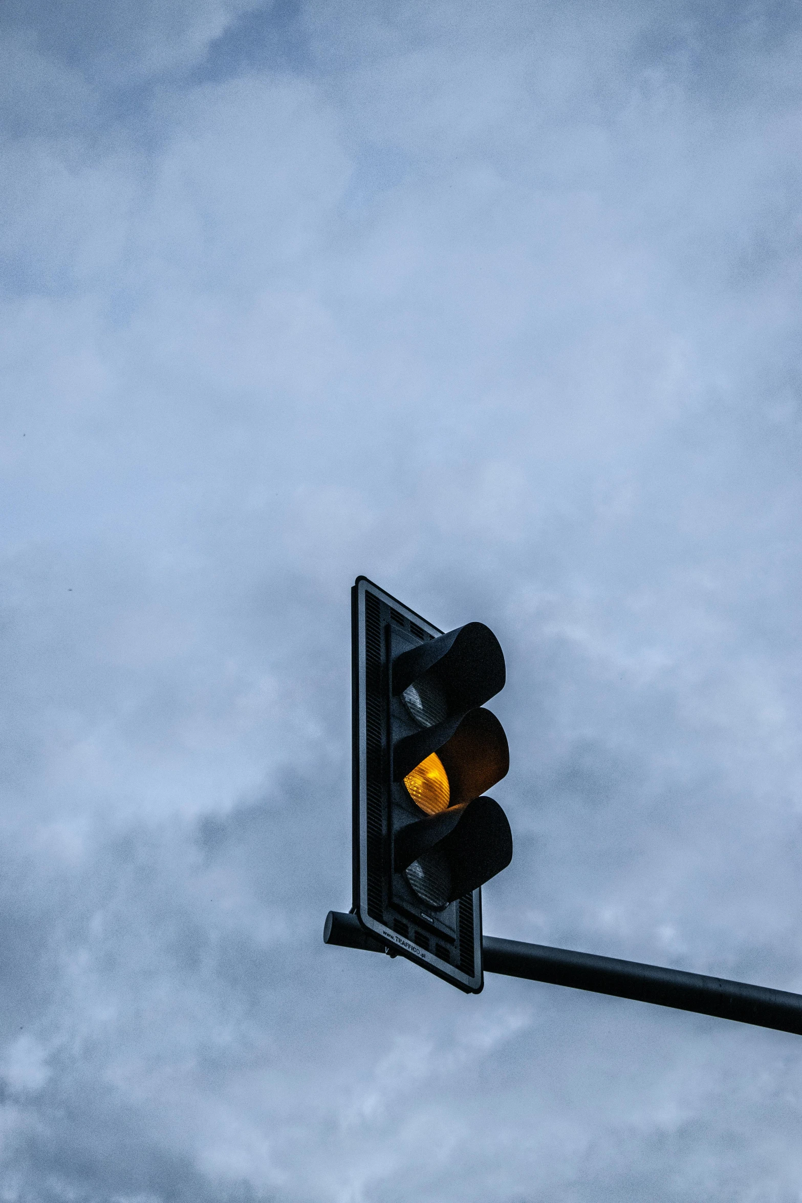 a stop light in the sky is shining yellow