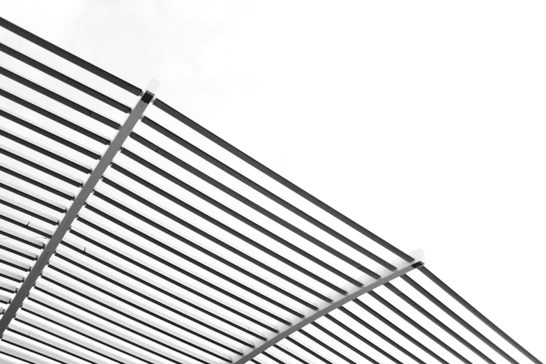 a black and white po of the top of a wall with metal bars attached