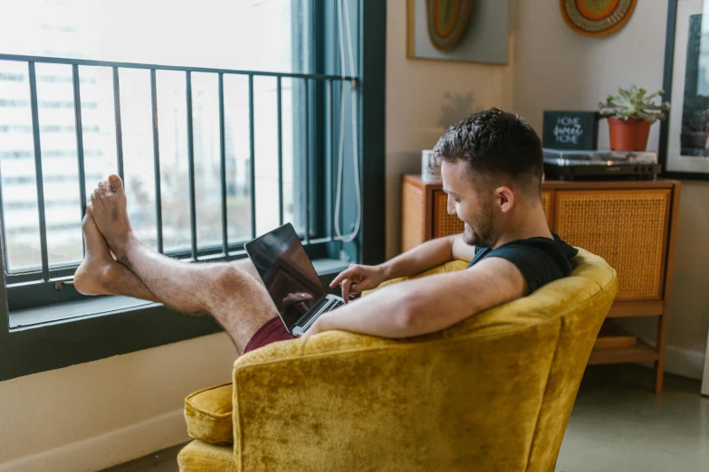 a man in the living room looking at the screen