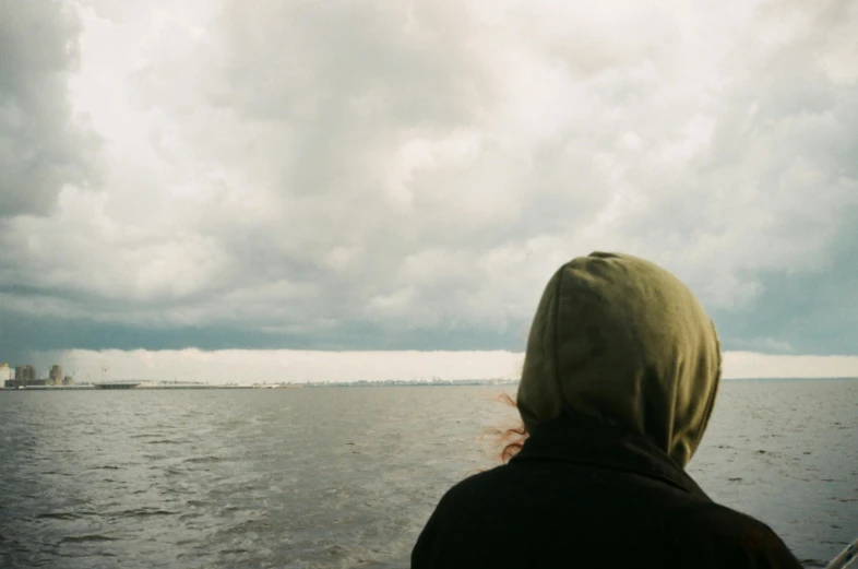 a woman looking out at a city on the water