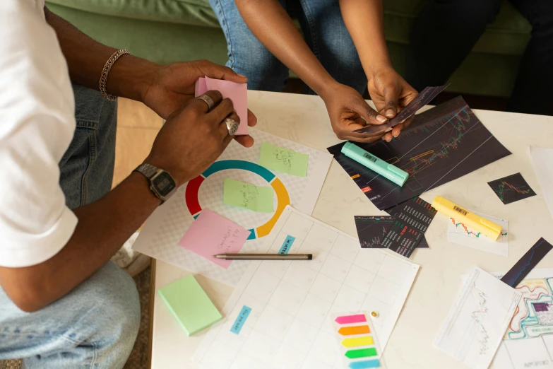 a group of people at a table with different items on it