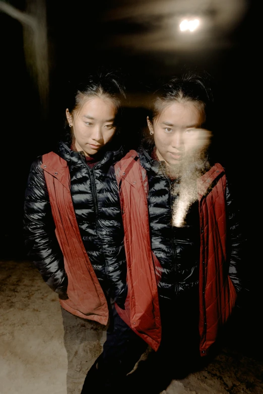 two people in black and red jackets posing for a po
