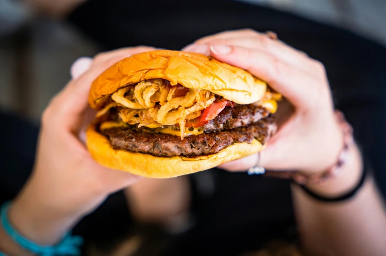 a large hamburger with meat and cheese