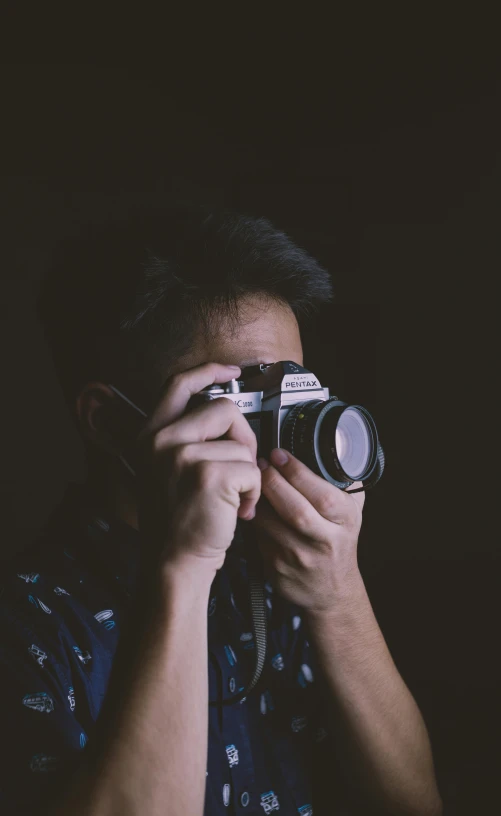 a man holding a camera to his face