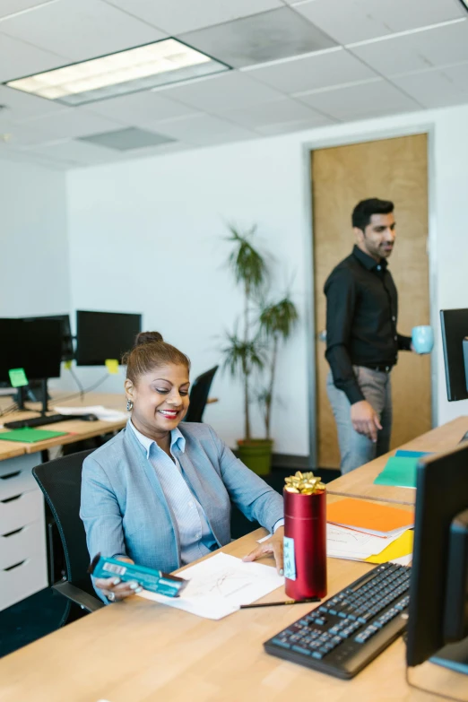 a business woman at her office talking on the phone and smiling