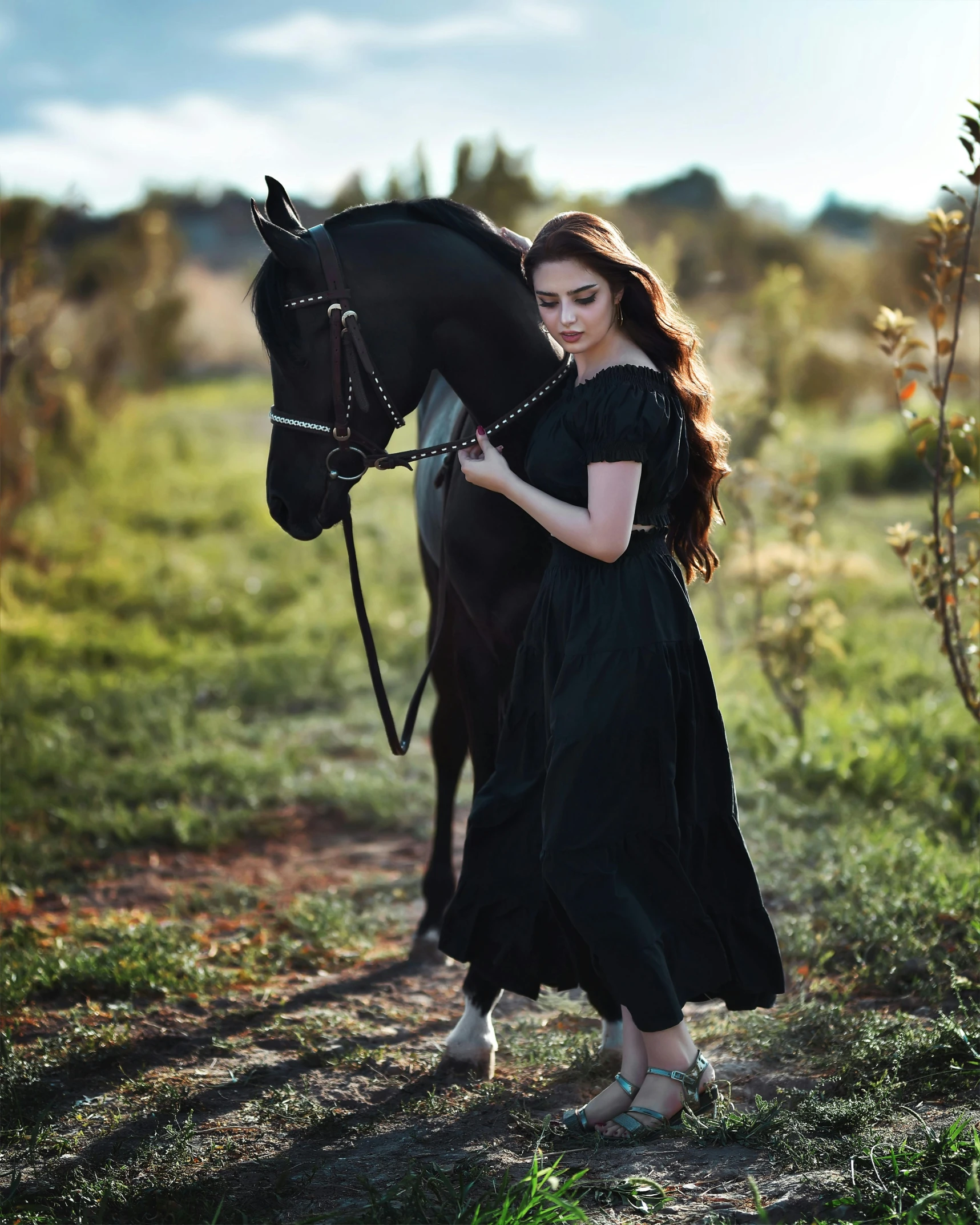 the woman is standing in front of a horse in a field