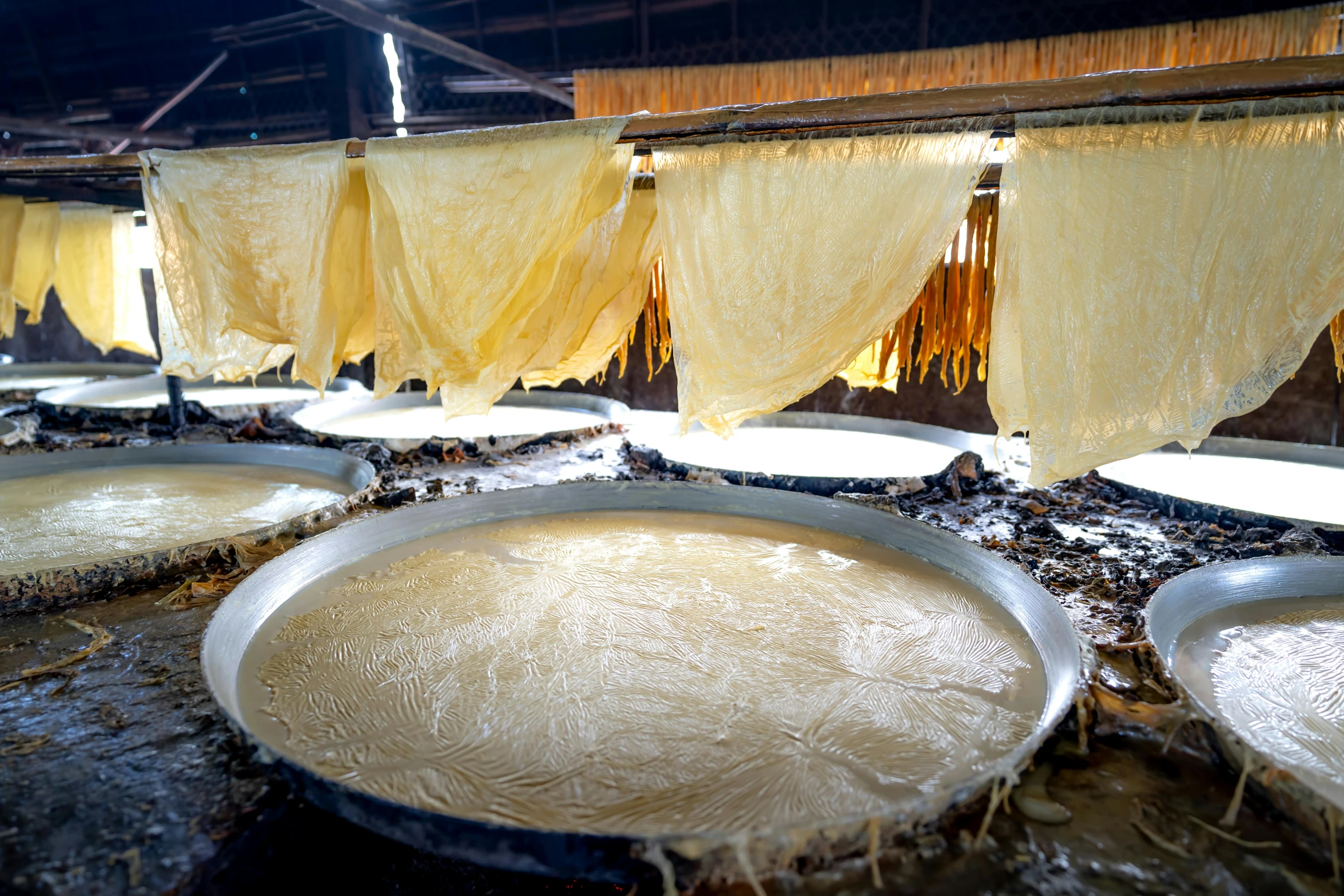 a bunch of pans with yellow curtains on them