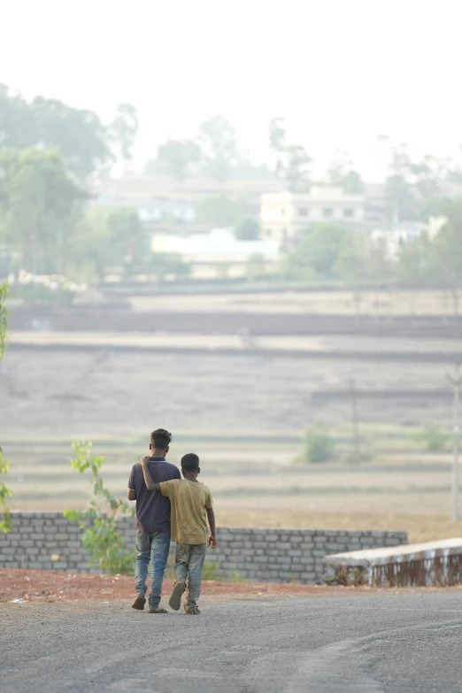 two people standing on the road looking out