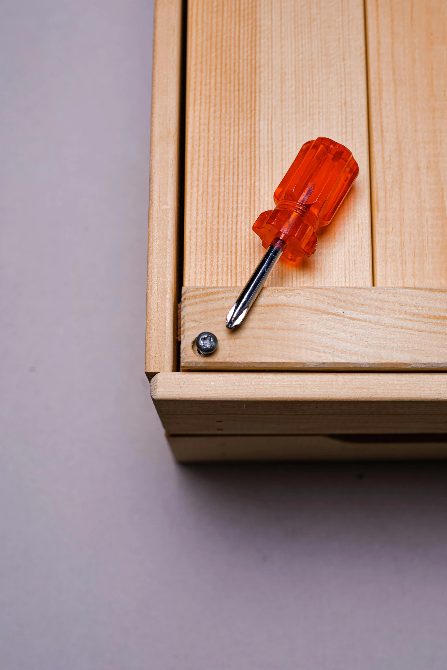 a hand held glass object on a wooden cabinet