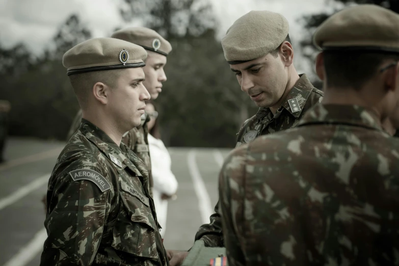 a group of military men talking next to each other