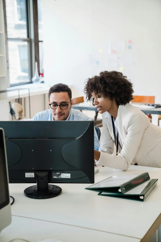 people in an office setting working on computers