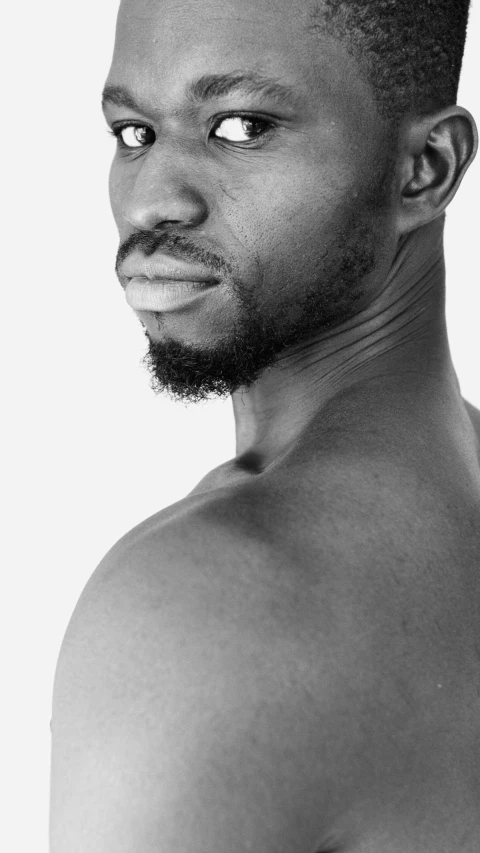 a black and white po of a man with a half shaved top