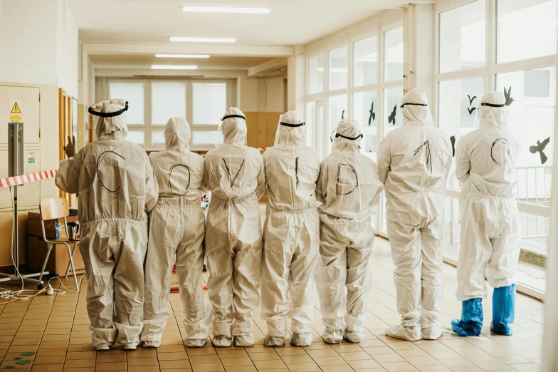 an exhibit of white people's suits on display in a hallway