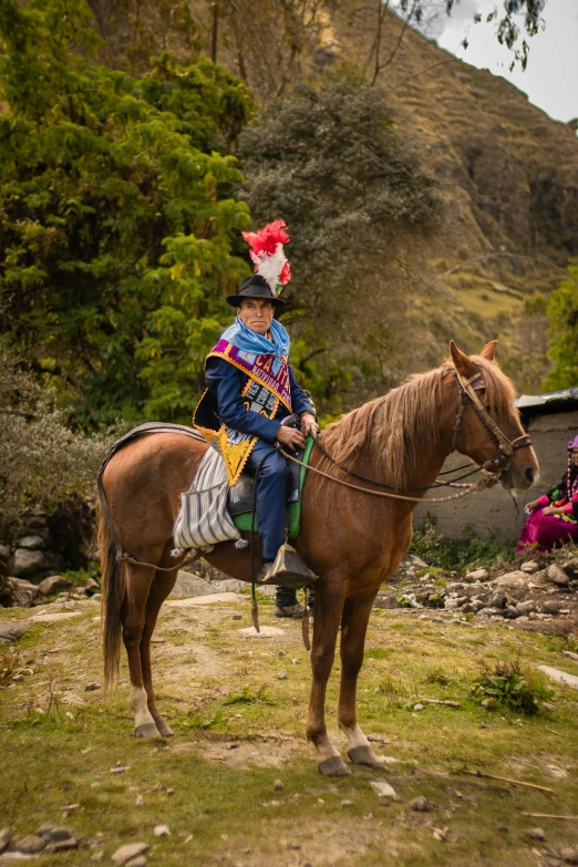 a man is riding on a horse and some people in the distance