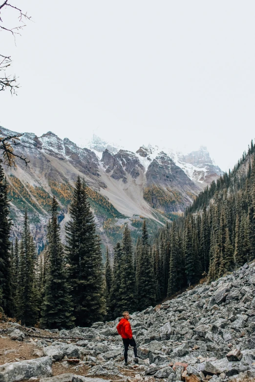 a man hiking up a mountain with snow on top