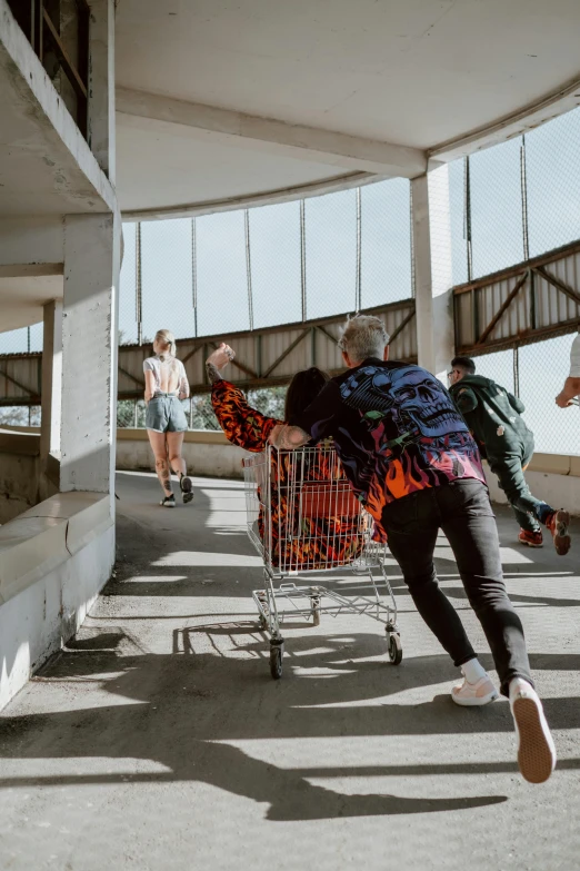 a young man is leaning over his shopping cart