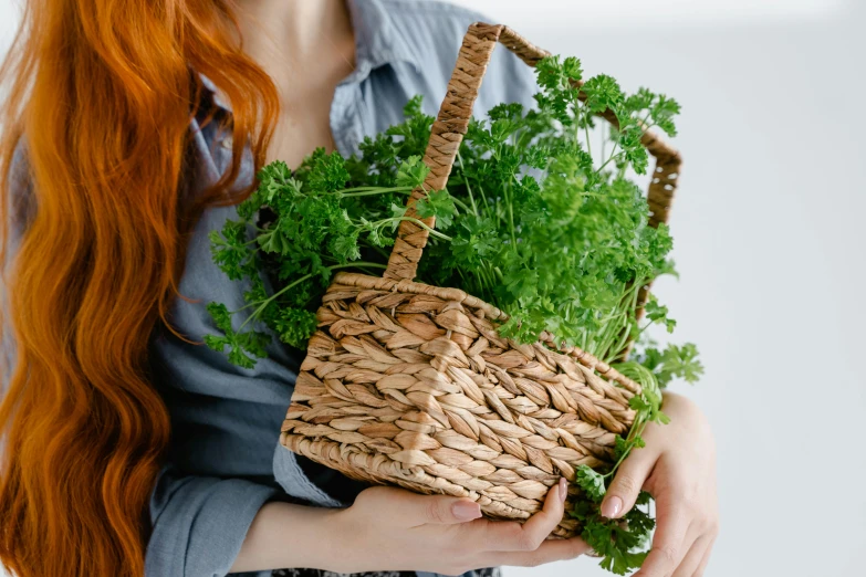 the woman is holding her green vegetable basket