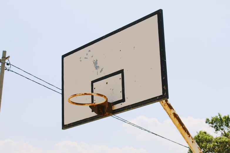 the hoop is attached to a pole and the basketball is ready for play