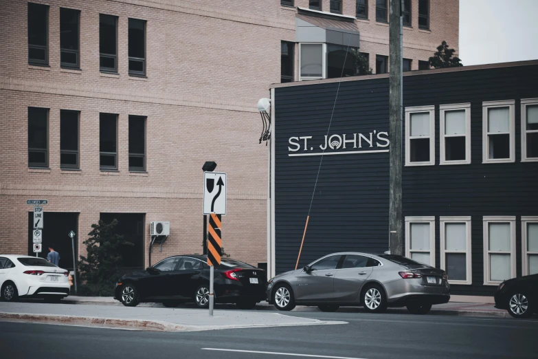 a couple of cars parked next to each other on a street